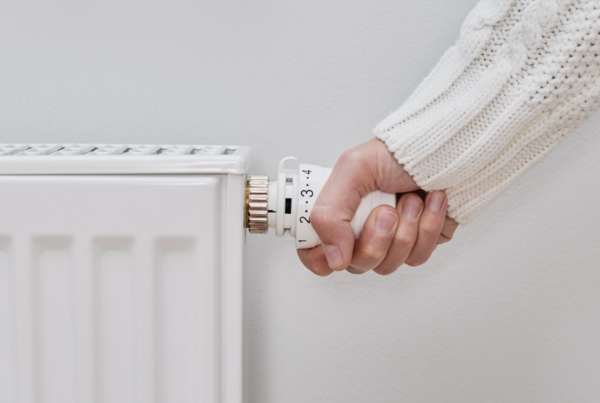 Heating engineers near me | Person switching on radiator