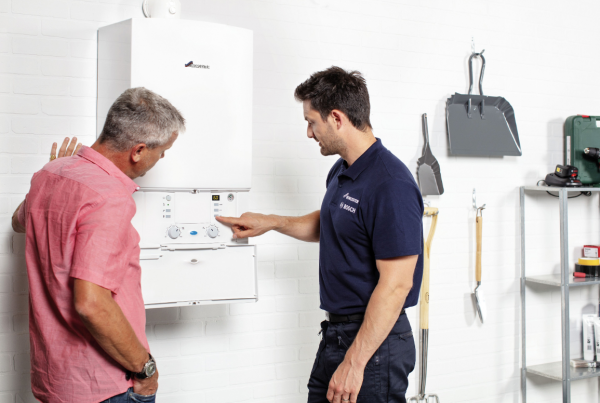 Private landlord | Engineer showing a person how to use a boiler.