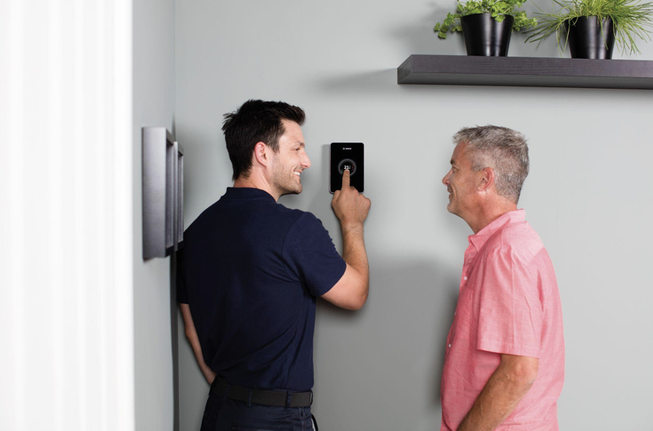 Central heating power flush | Engineer showing central heating controls to homeowner.