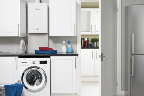 boiler types | Boiler in a kitchen environment with washing machine and other appliances.